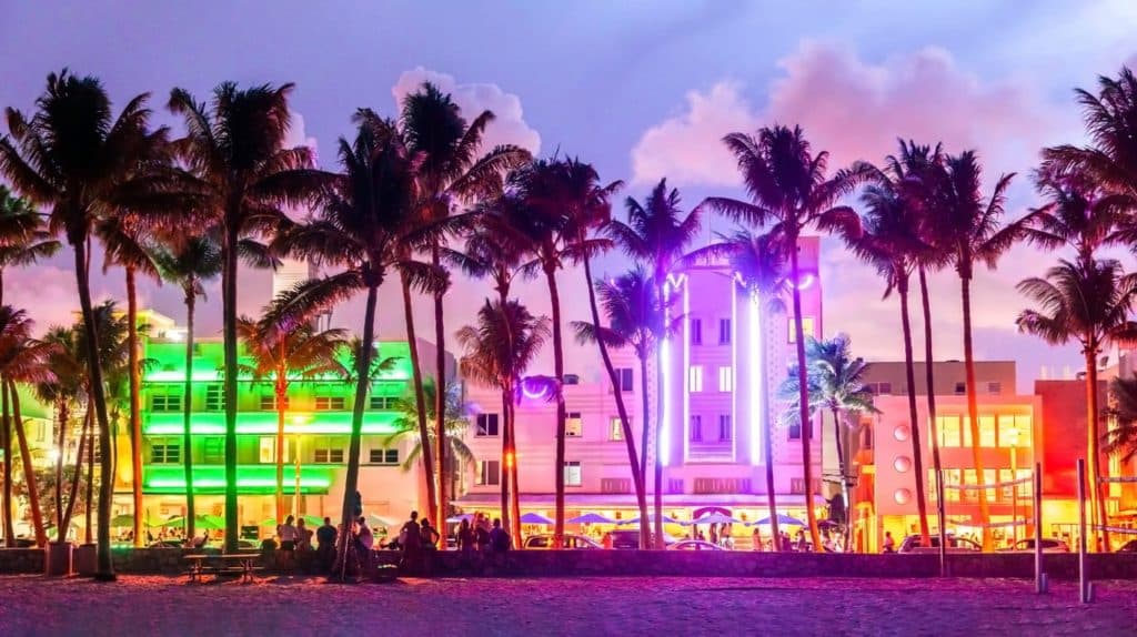 A view of Miami hotels lit up by neon lights